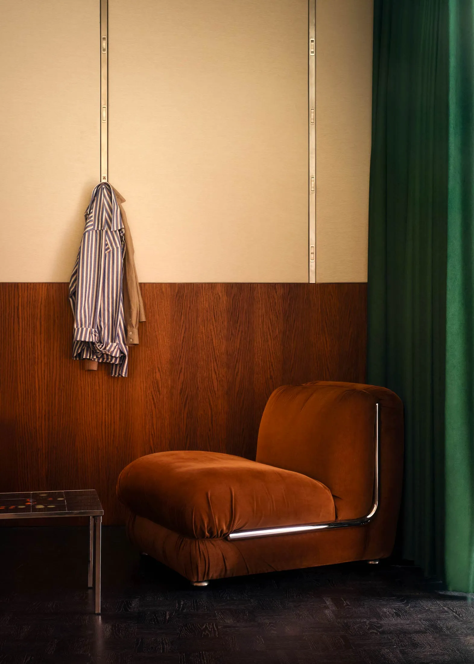 A cozy, amber-colored velvet armchair in a stylish living room setting.