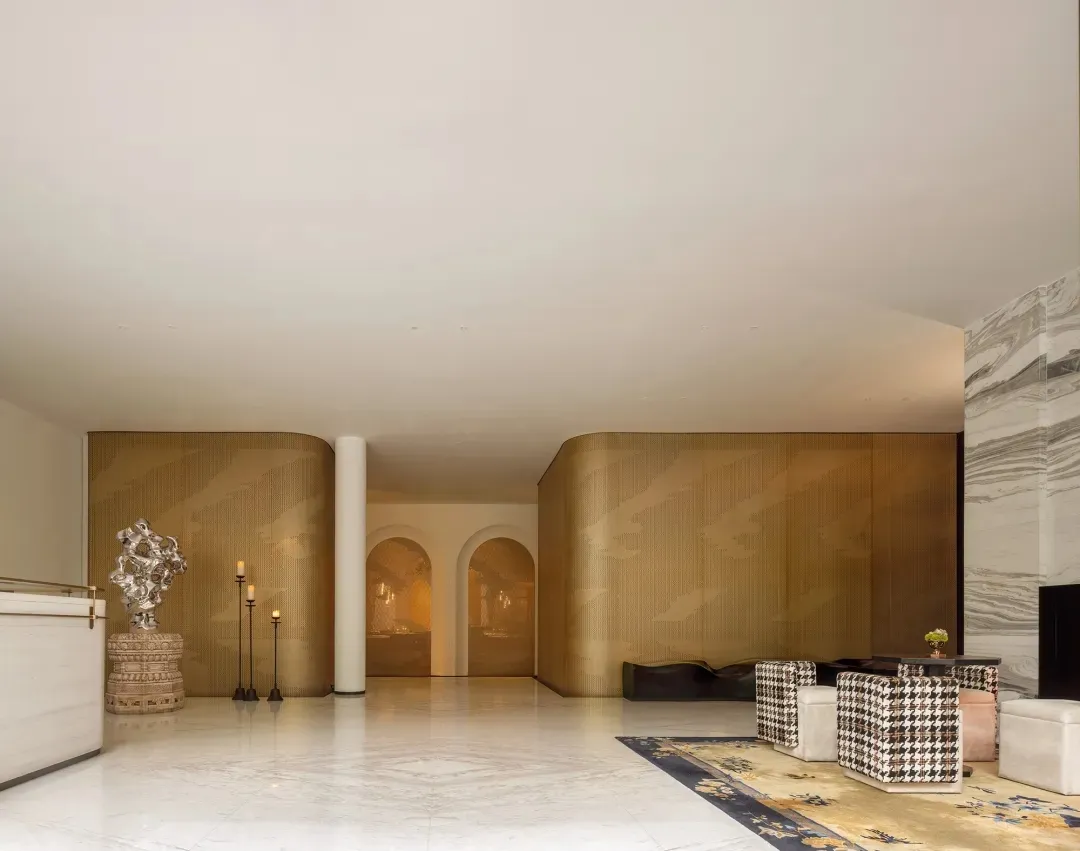 Modern lobby interior featuring metallic-textured paneled walls
