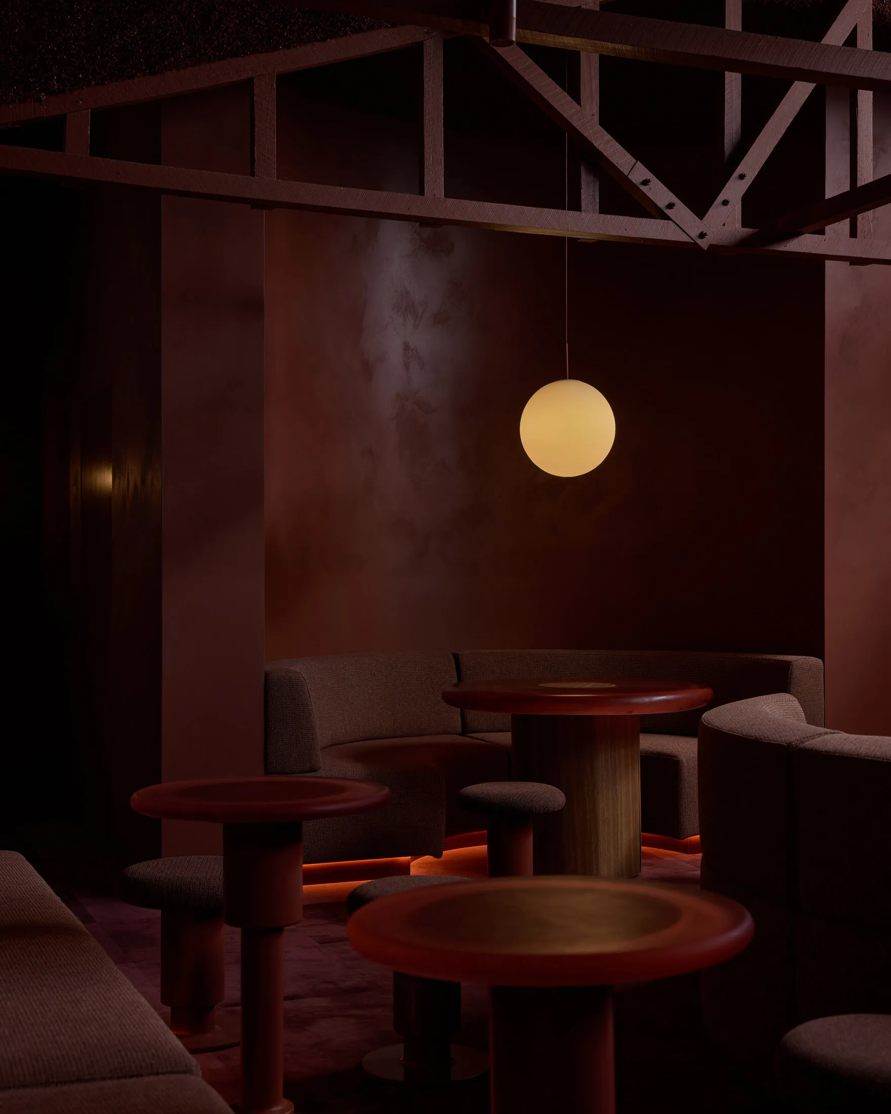 Circular tables and seating with modern interior design elements in a restaurant bar setting.