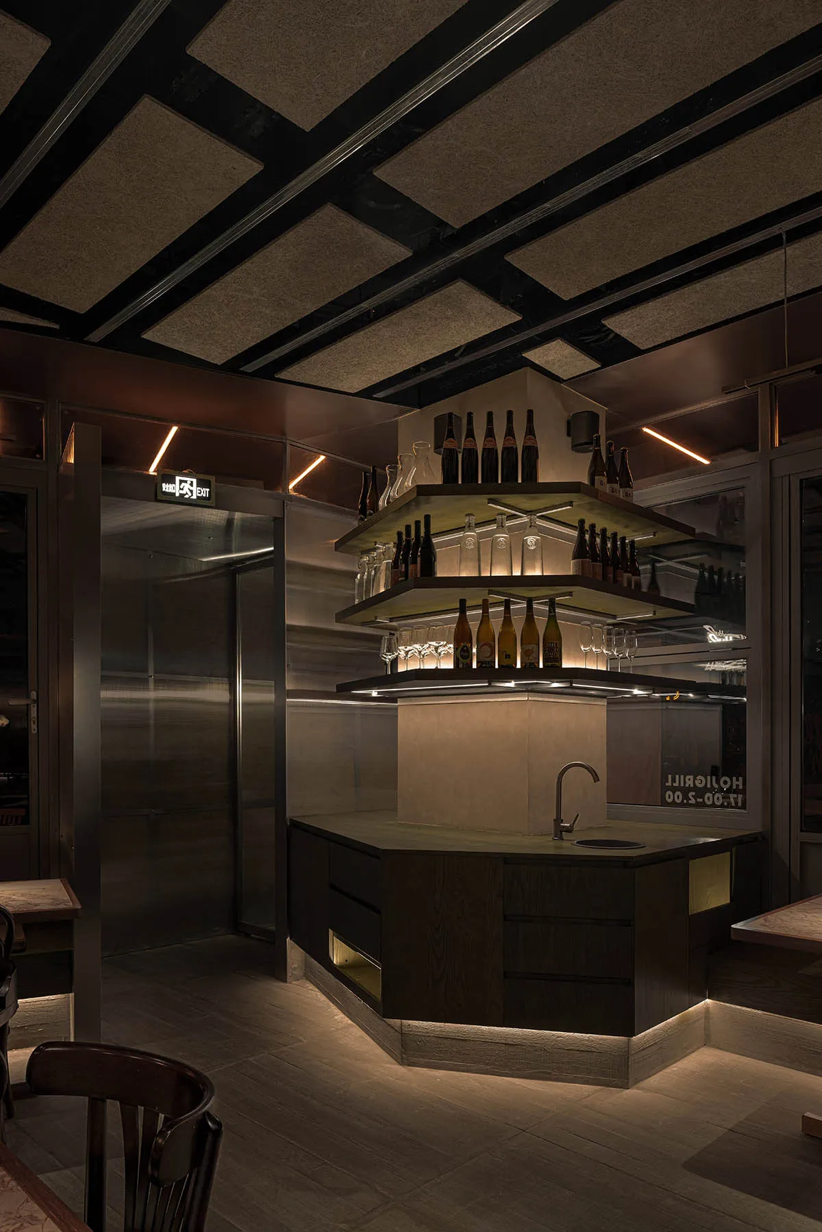 Interior of an industrial-themed restaurant bar featuring metal and wooden elements