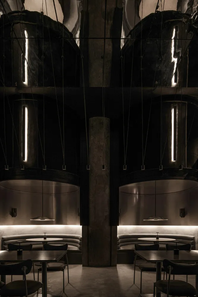 Industrial-style restaurant interior featuring metallic elements and modern seating.
