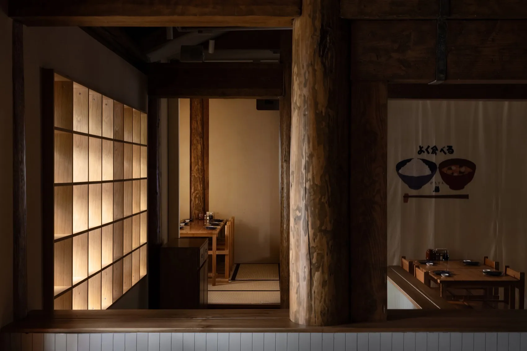 A photograph of a wooden-restaurant interior with soft lighting.