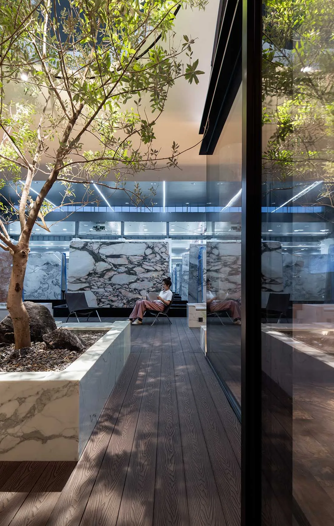 A minimalist modern office lounge featuring glass planters.