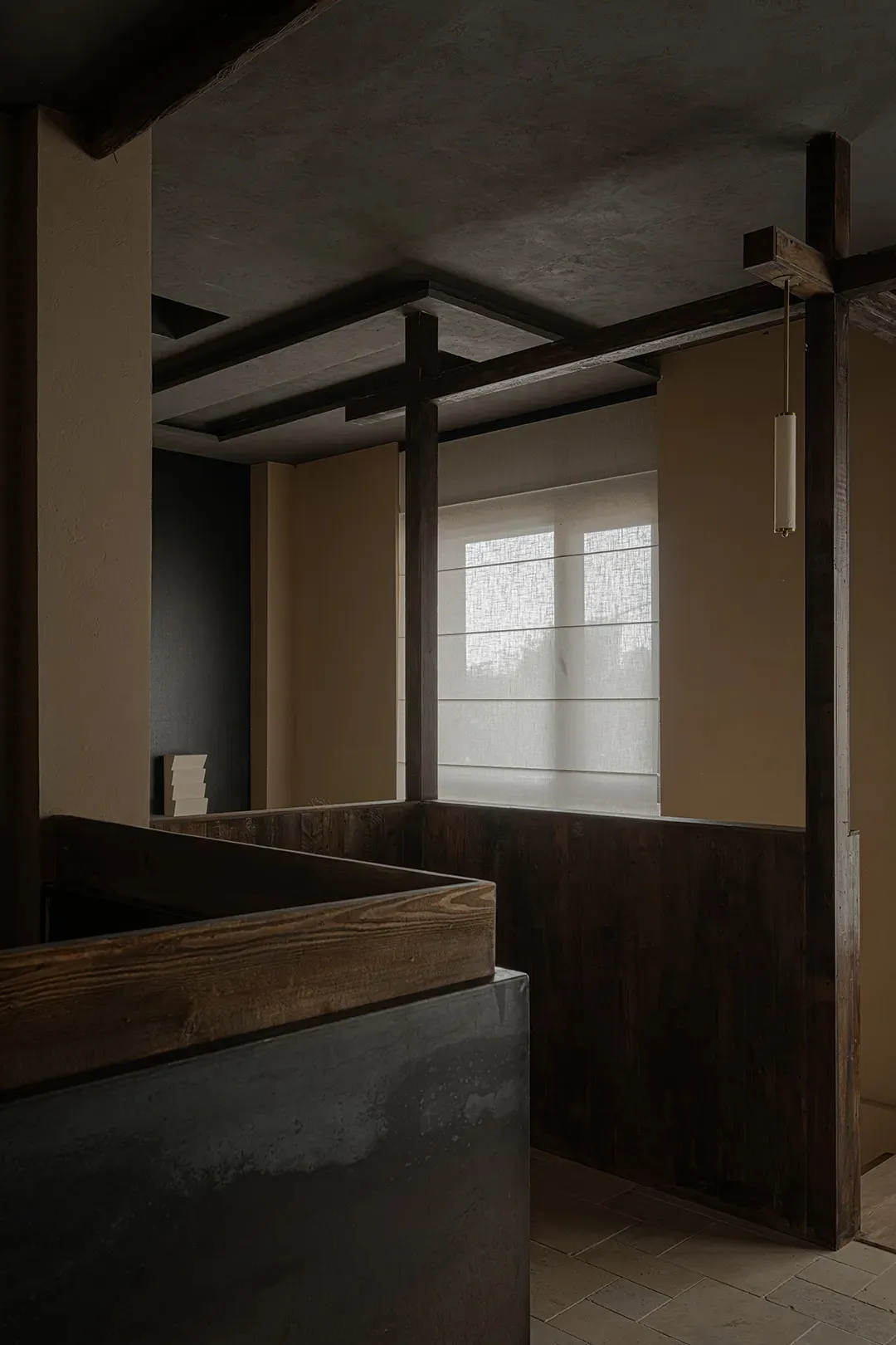 Modern bathroom with concrete walls and wooden accents.