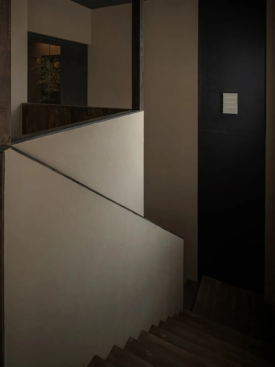 An image featuring a set of stairs with industrial brown painted wall paneling.
