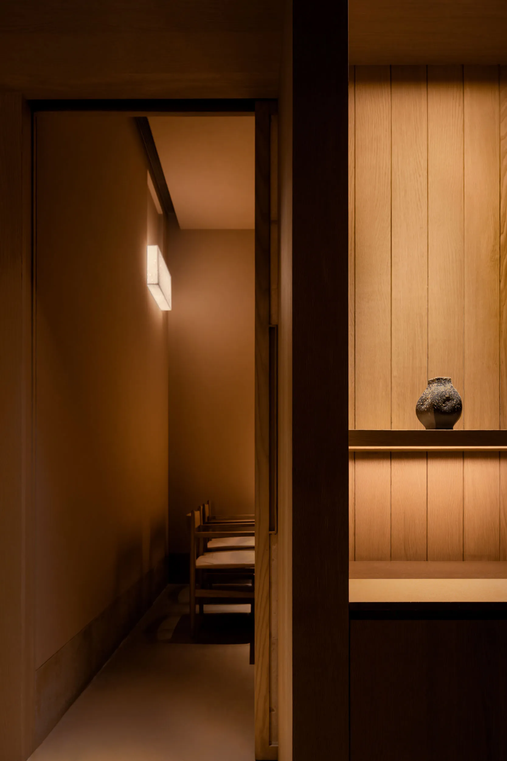 Modern restaurant space featuring wooden materials and minimalist design.