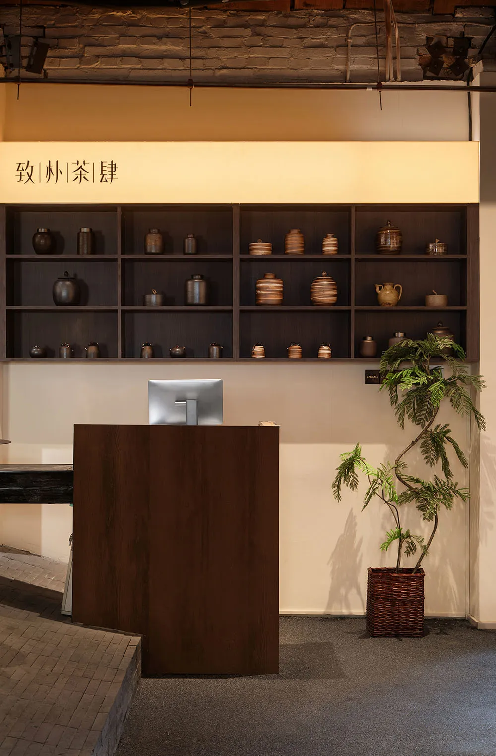 零售櫃台擺放各式陶瓷罐,搭配磚牆、木質層板與金屬桌。