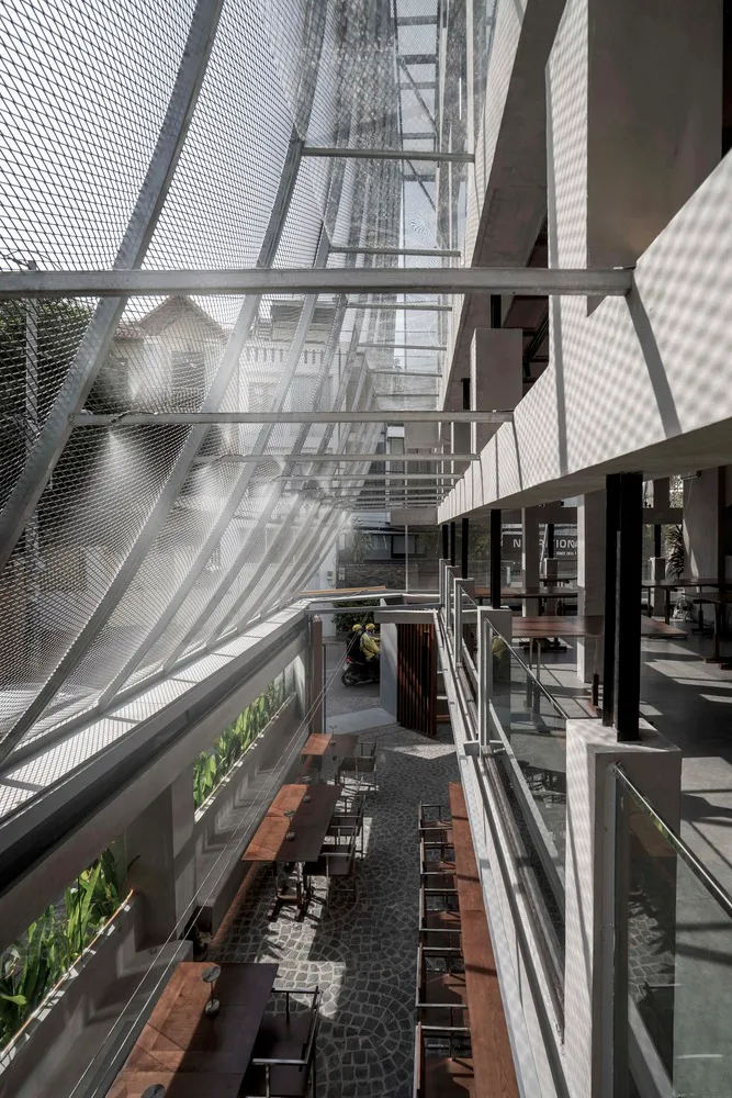 Interior design of a modern cafeteria with glass walls and concrete flooring.