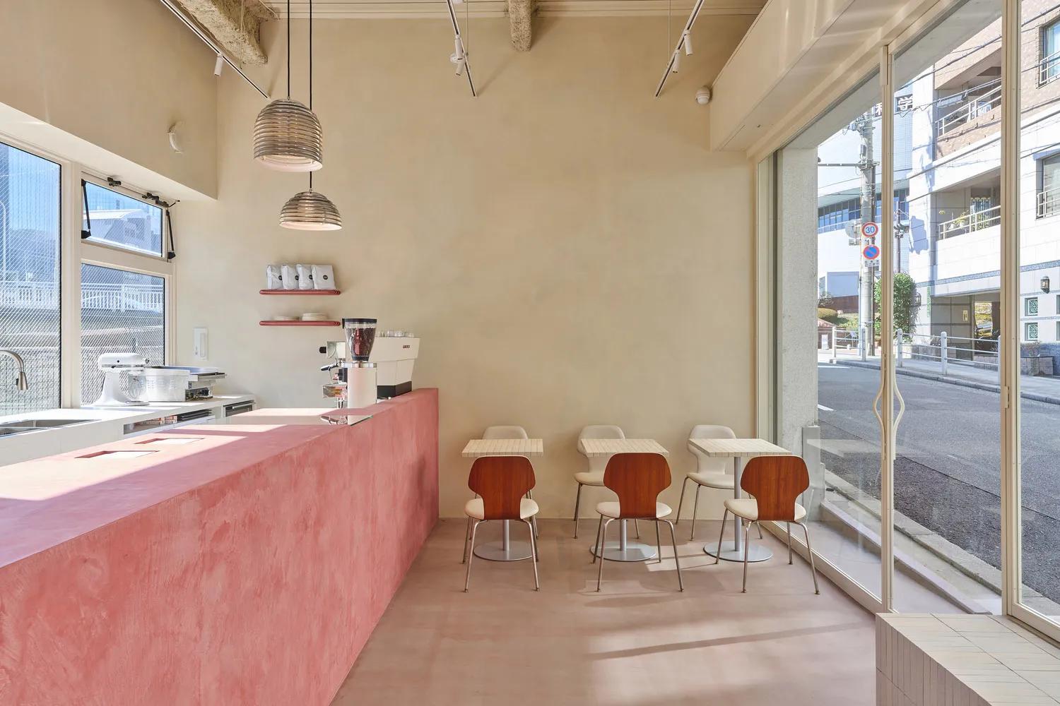 A minimalist cafe with concrete finishes and glass windows