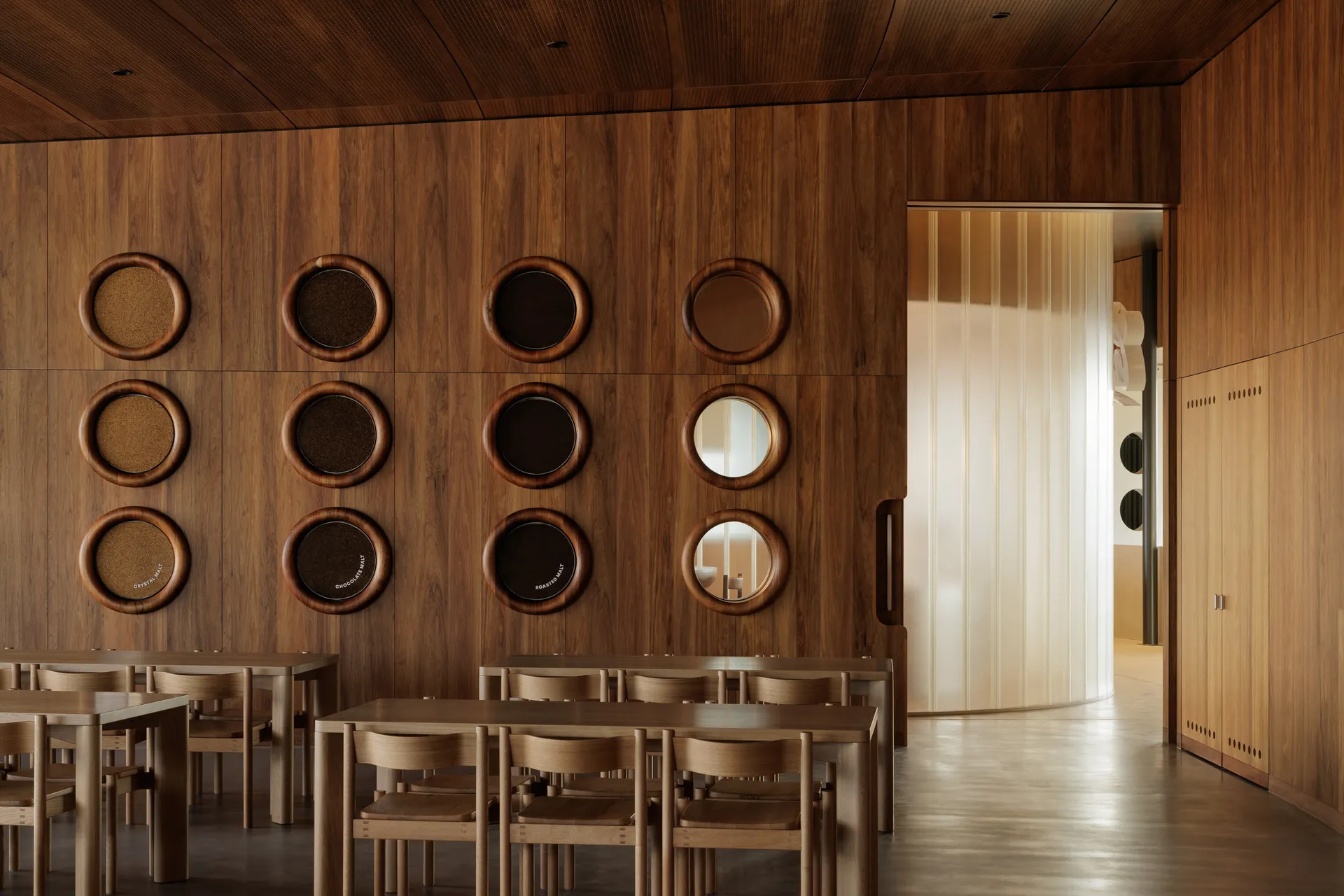 A modern cafe interior with wooden walls, round glass windows, round tables, and chairs.