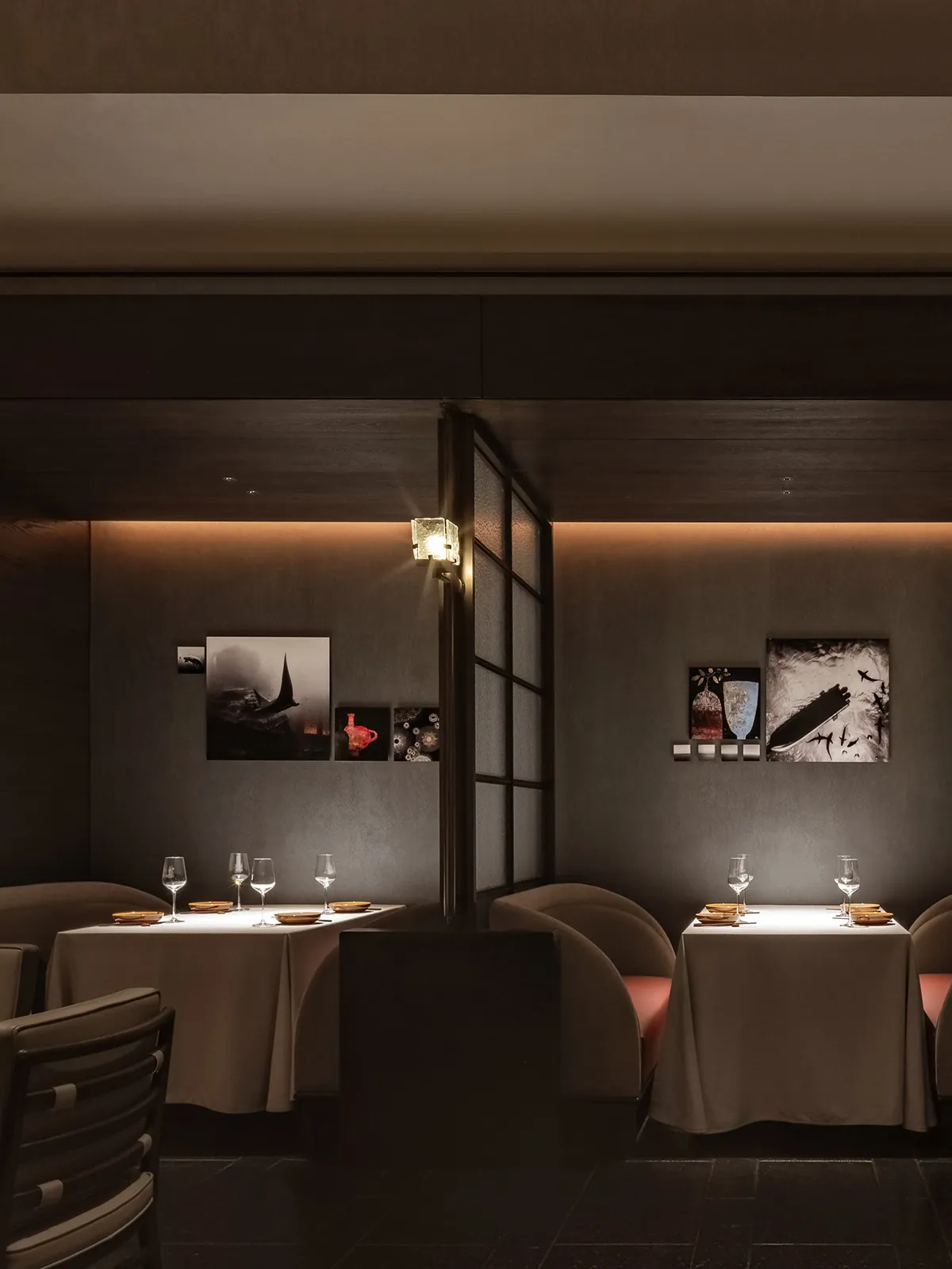 A minimalist restaurant interior with modern design elements and neutral color palette, featuring sleek seating, elegant tabl