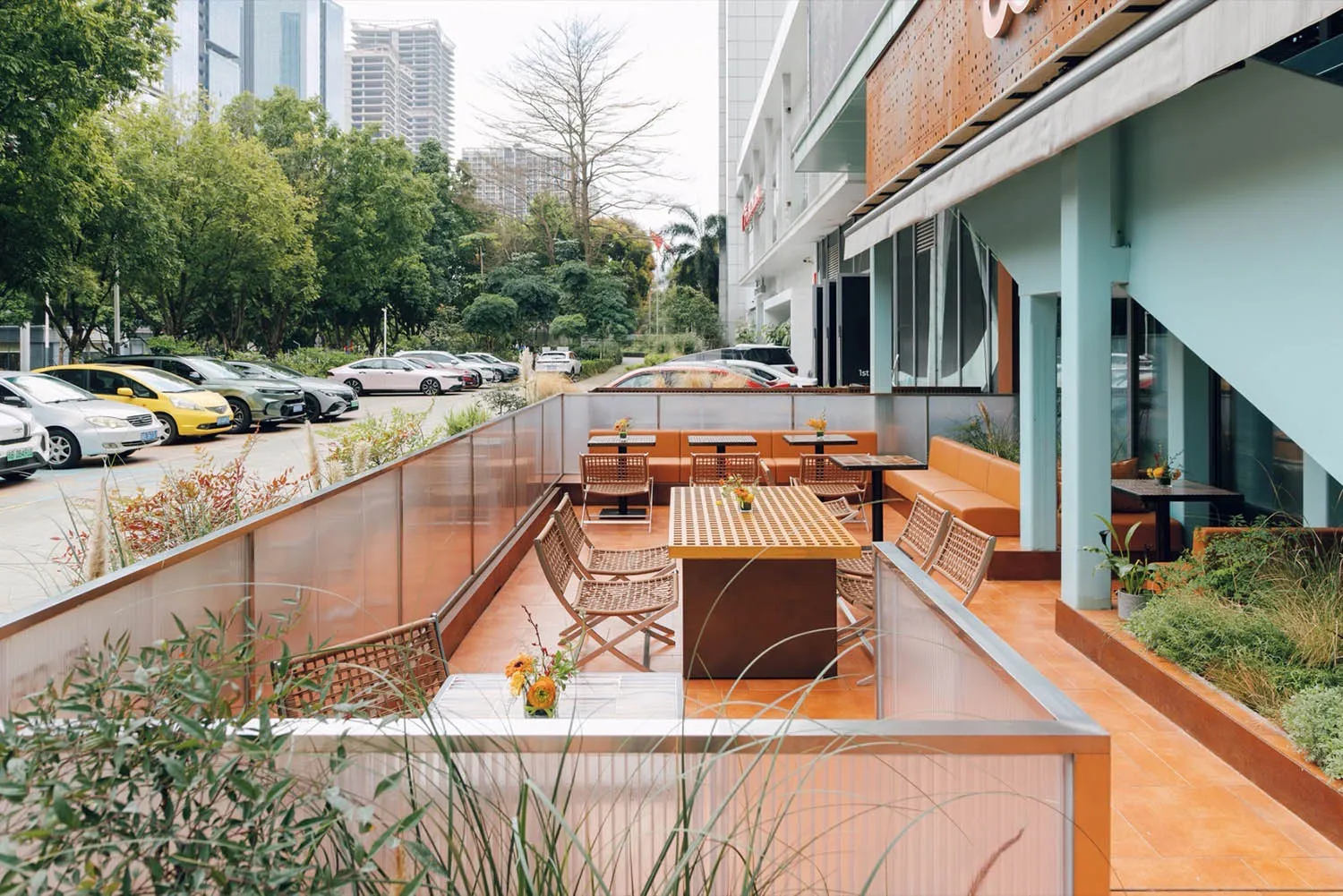 An outdoor cafe with modern design features, including concrete seating and tables.
