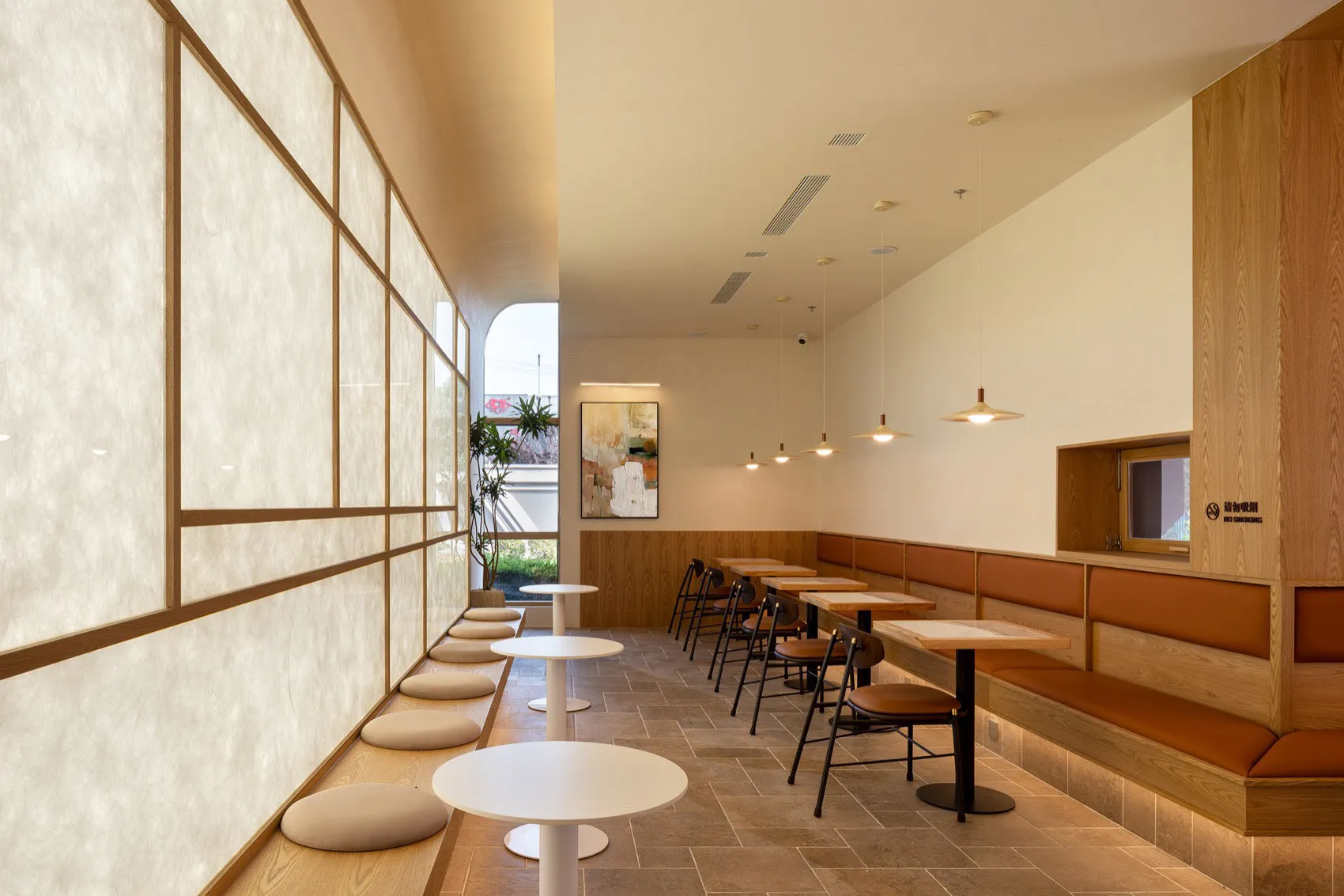 Modern cafe interior with wooden furniture and seating areas