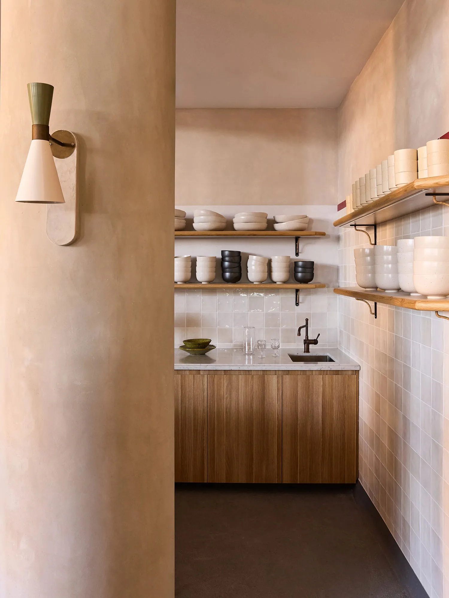 Minimalist kitchen featuring ceramic shelves and storage solutions.