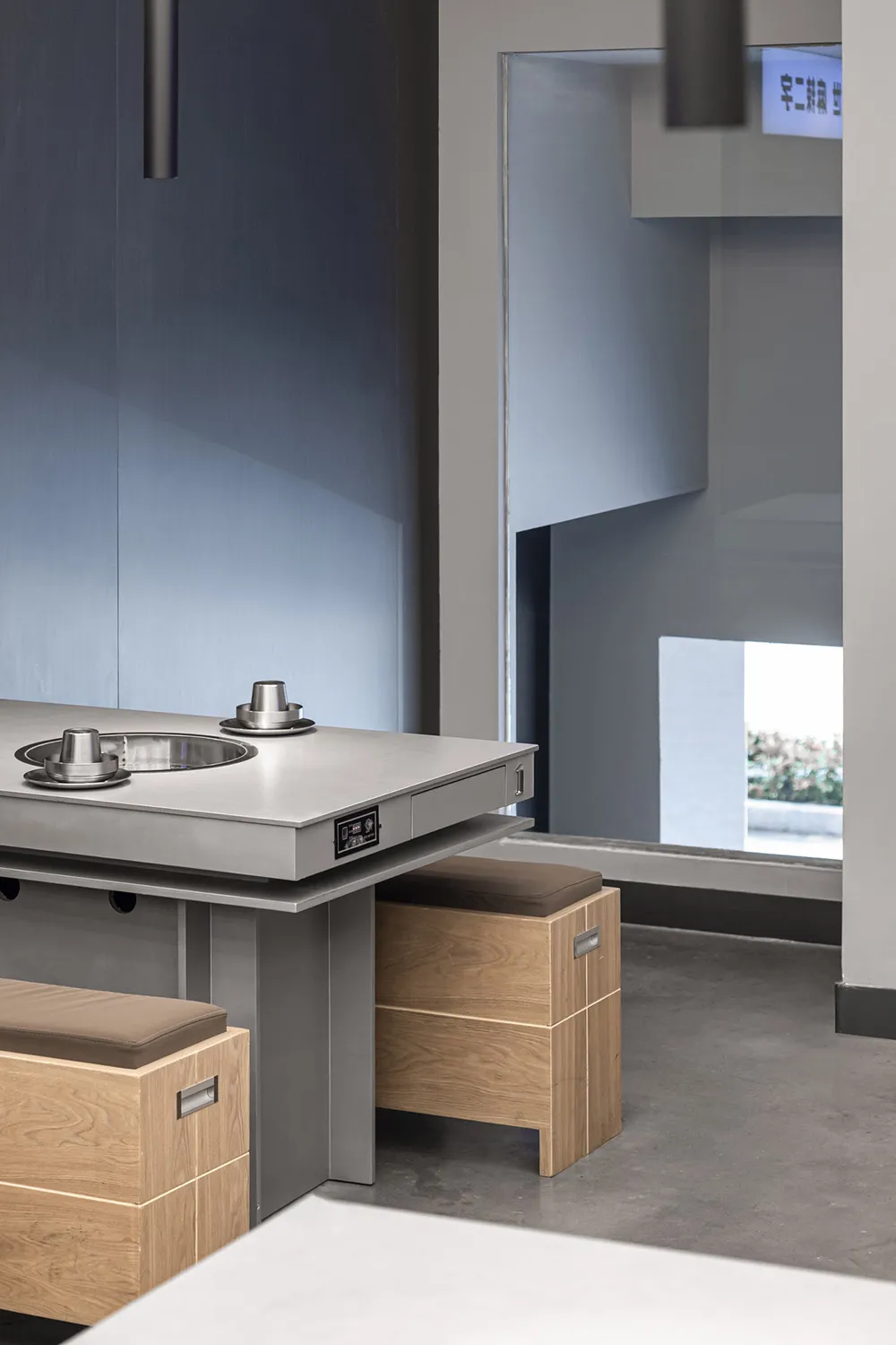 Modern industrial kitchen with metal countertop and seating