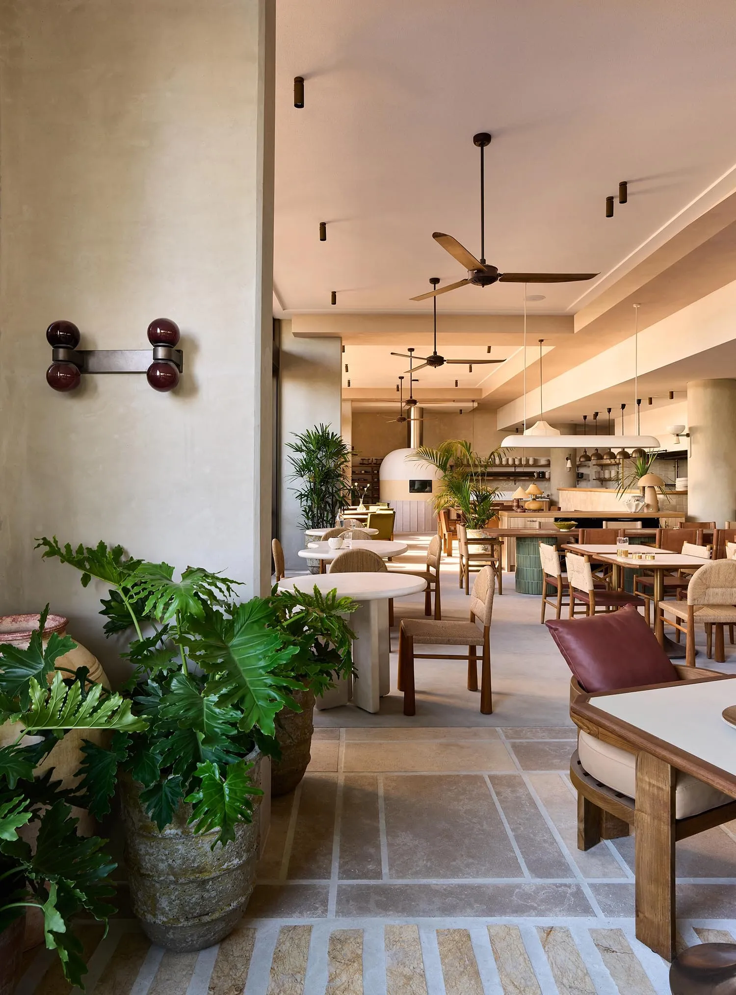 Modern restaurant interior with concrete and wooden features.