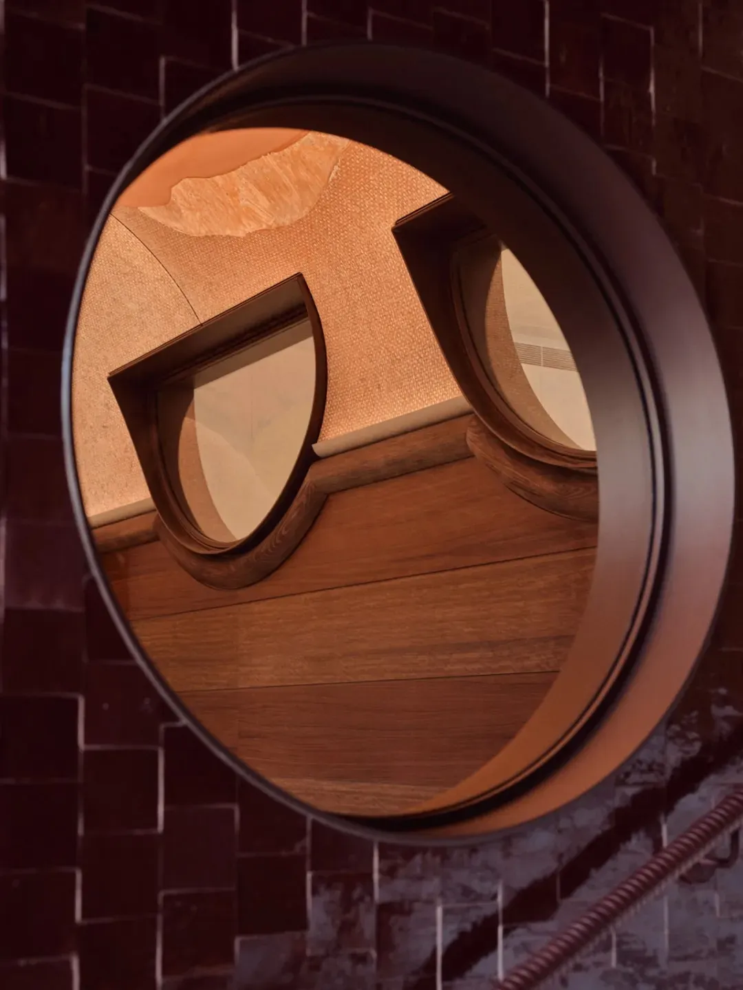 A modern interior with a round window and wooden beams