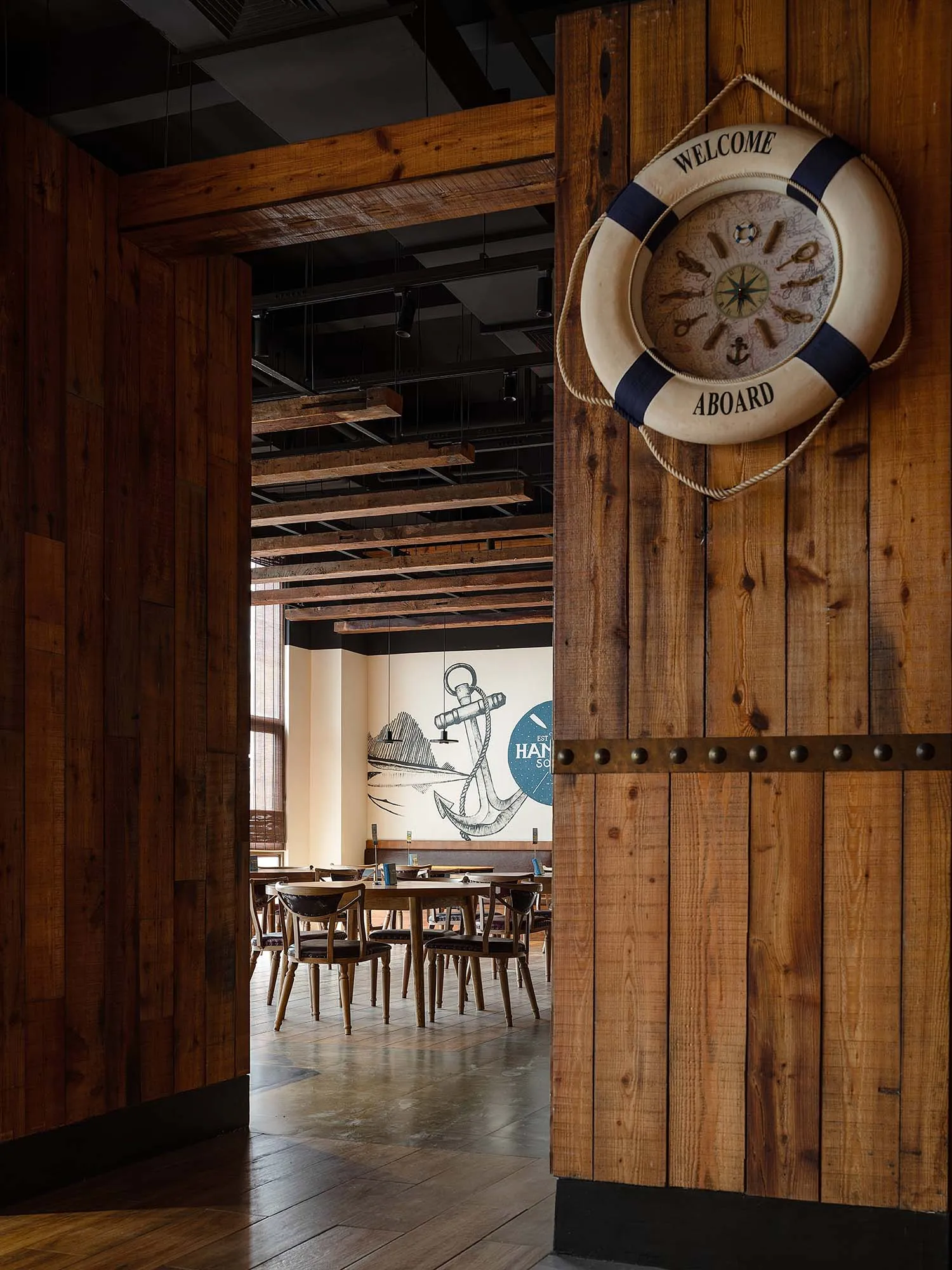 A wooden restaurant interior with a nautical theme.