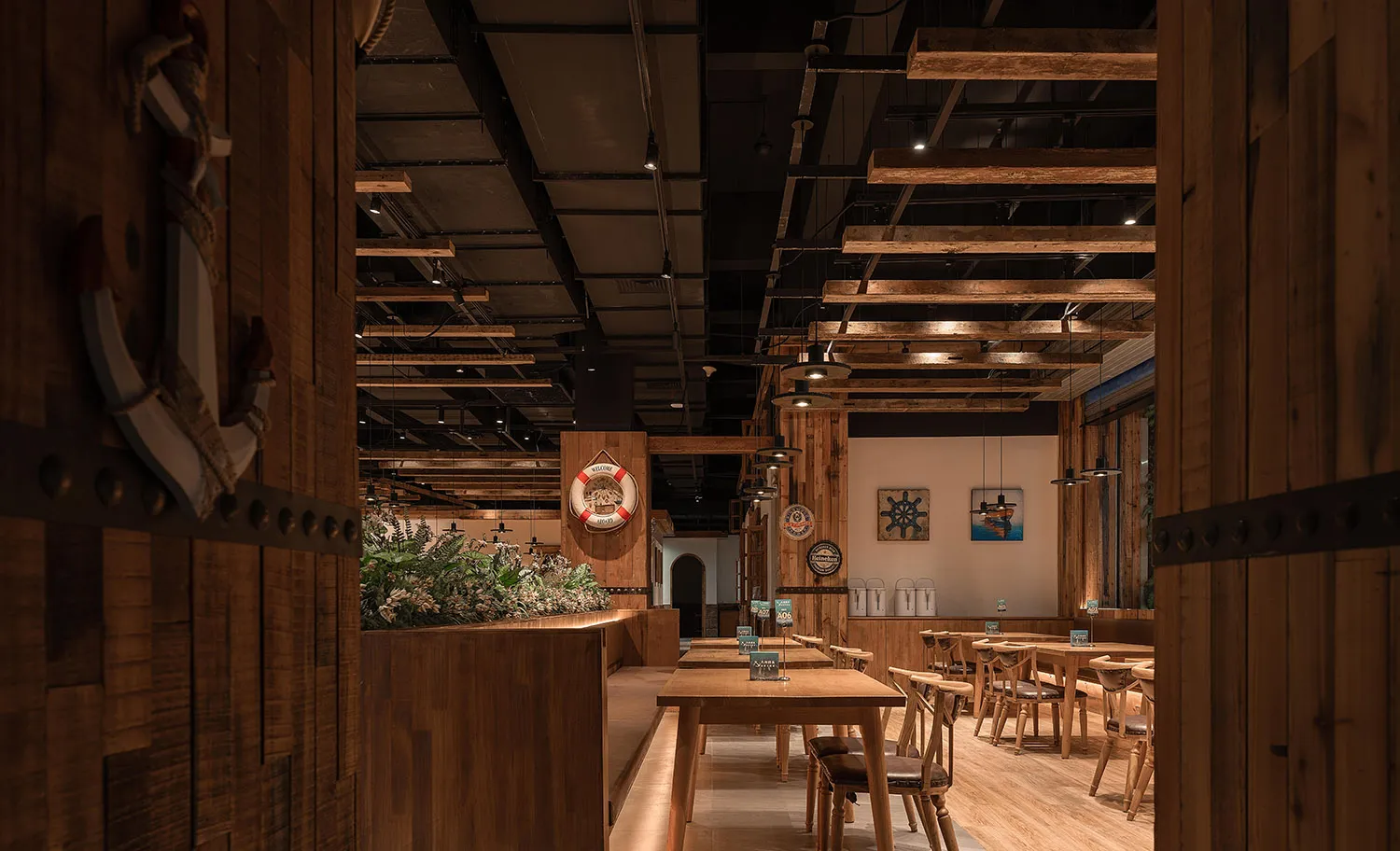 Interior of a restaurant with industrial design elements made of wood, including wooden tables, chairs, and ceiling beams.