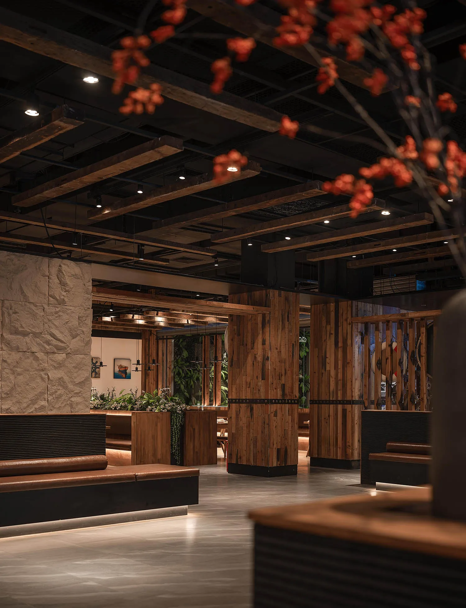 A modern restaurant interior with wooden and concrete elements.