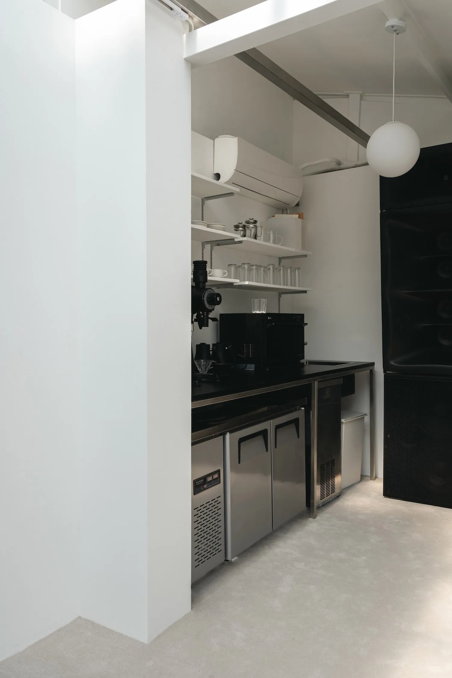 A modern minimalist kitchen featuring metal cabinets and countertops.