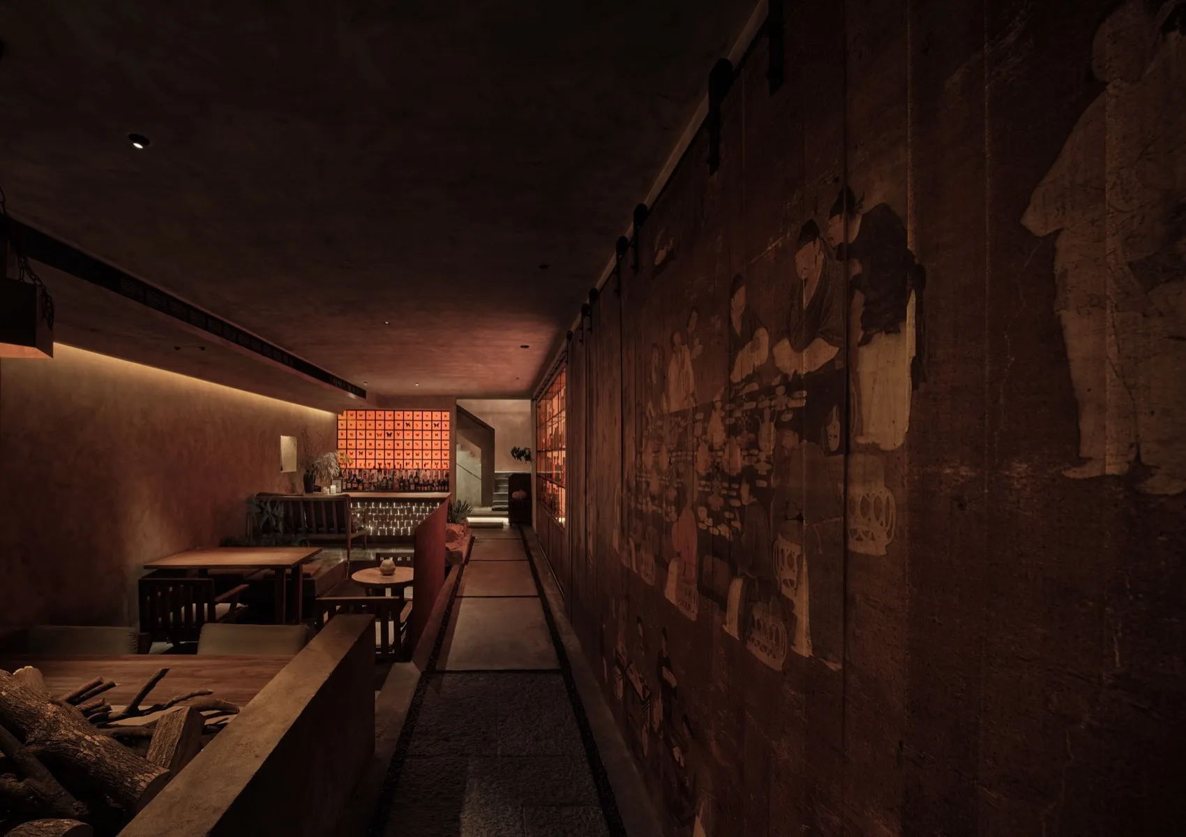 A dimly lit industrial-style restaurant bar with rustic wooden walls and tables.