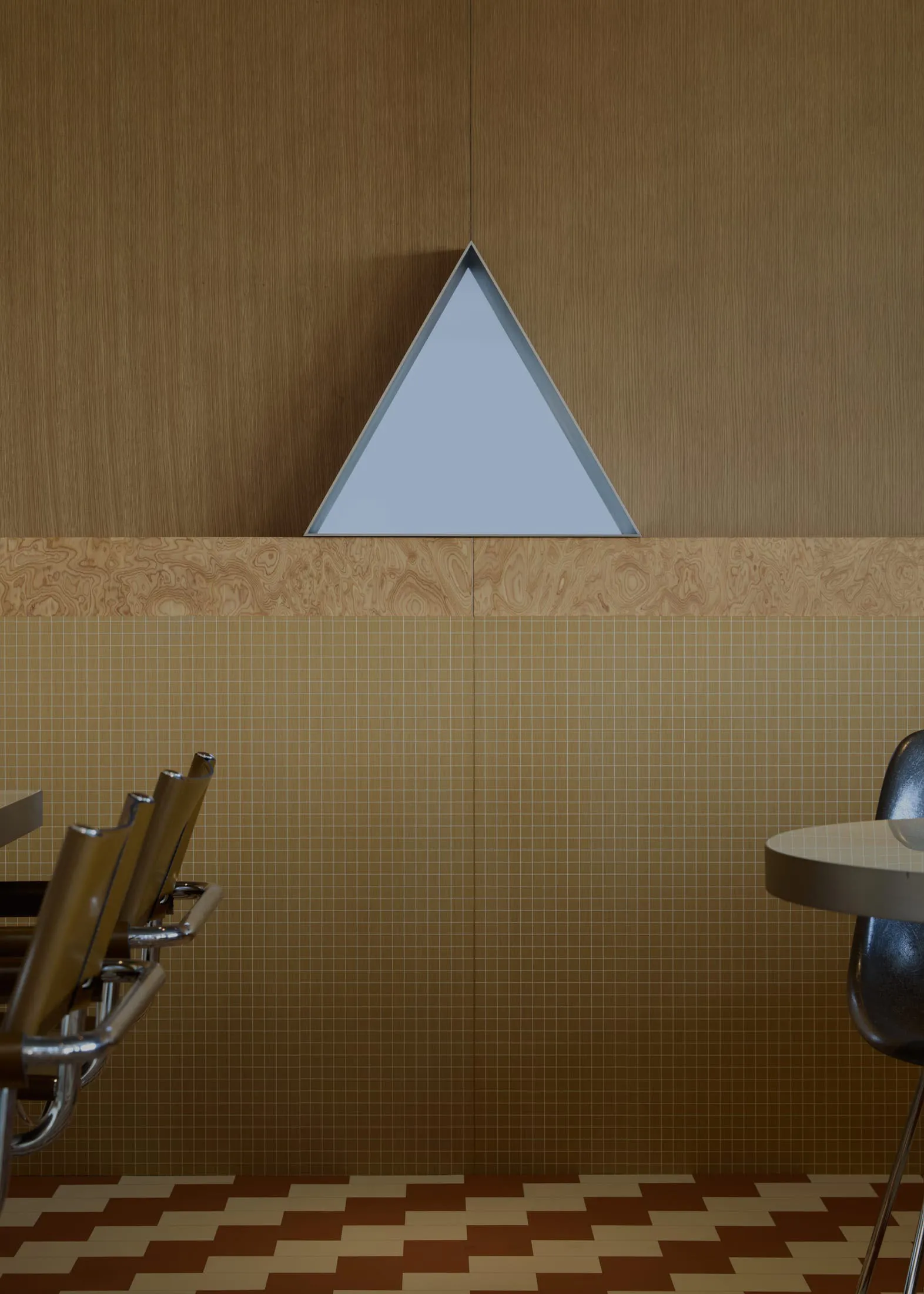 Modern interior design featuring wooden walls and a geometric triangle wall feature.