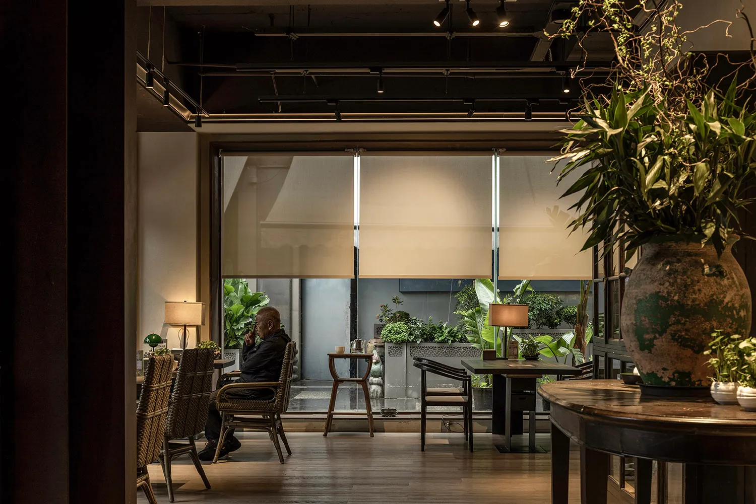 Industrial-style restaurant interior with glass windows.