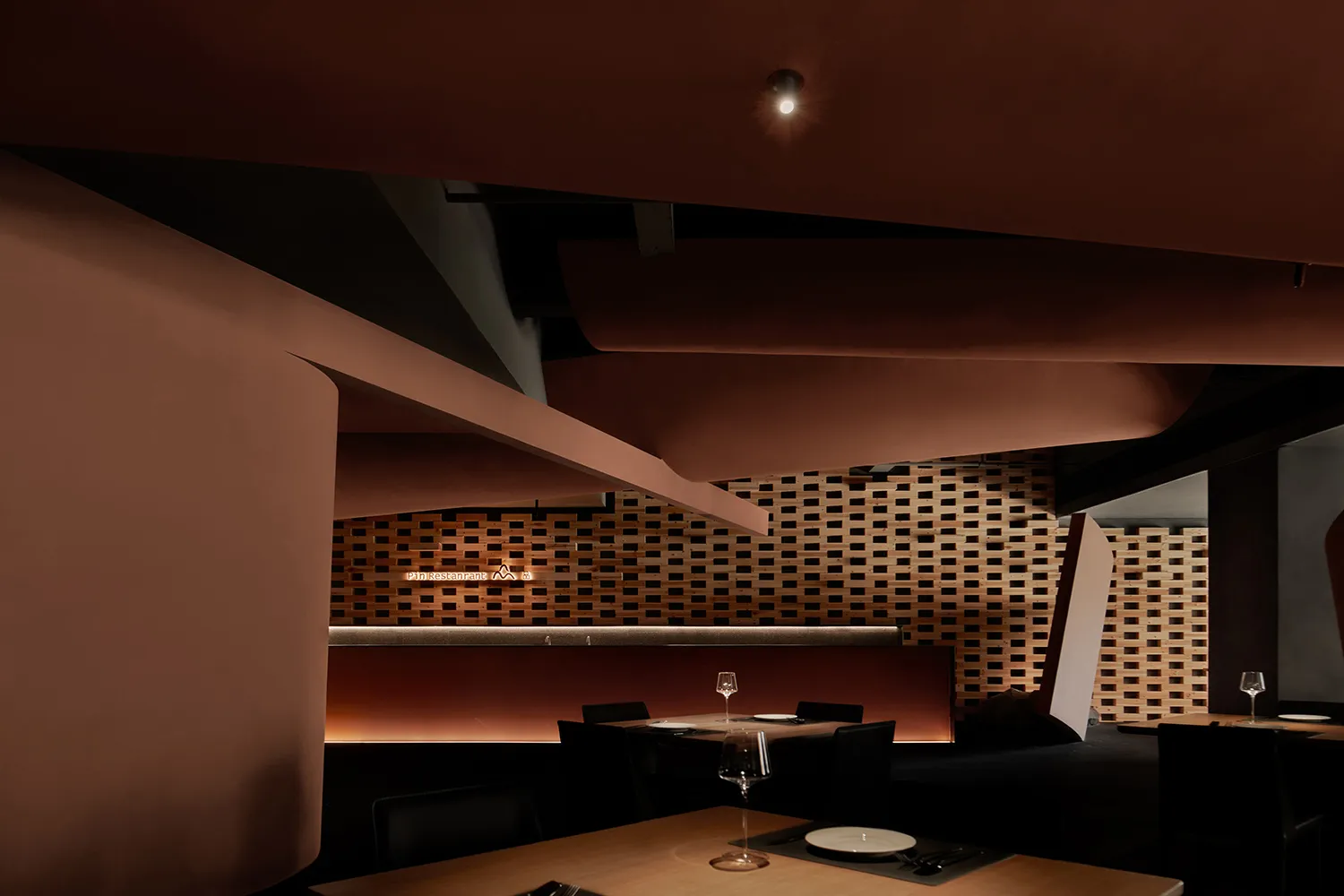 A modern restaurant interior featuring brick and wooden elements.