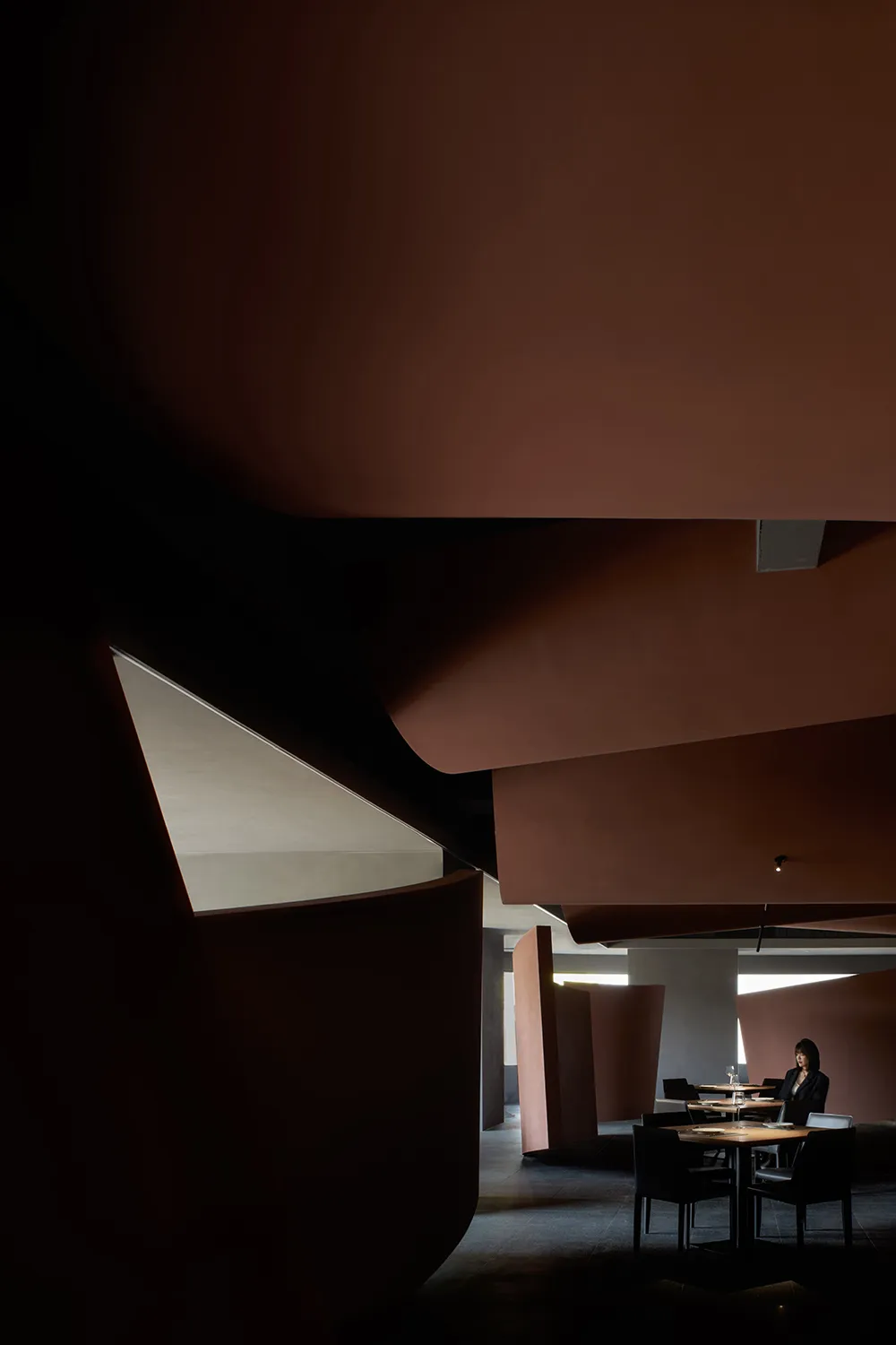Modern restaurant interior with concrete and wood elements