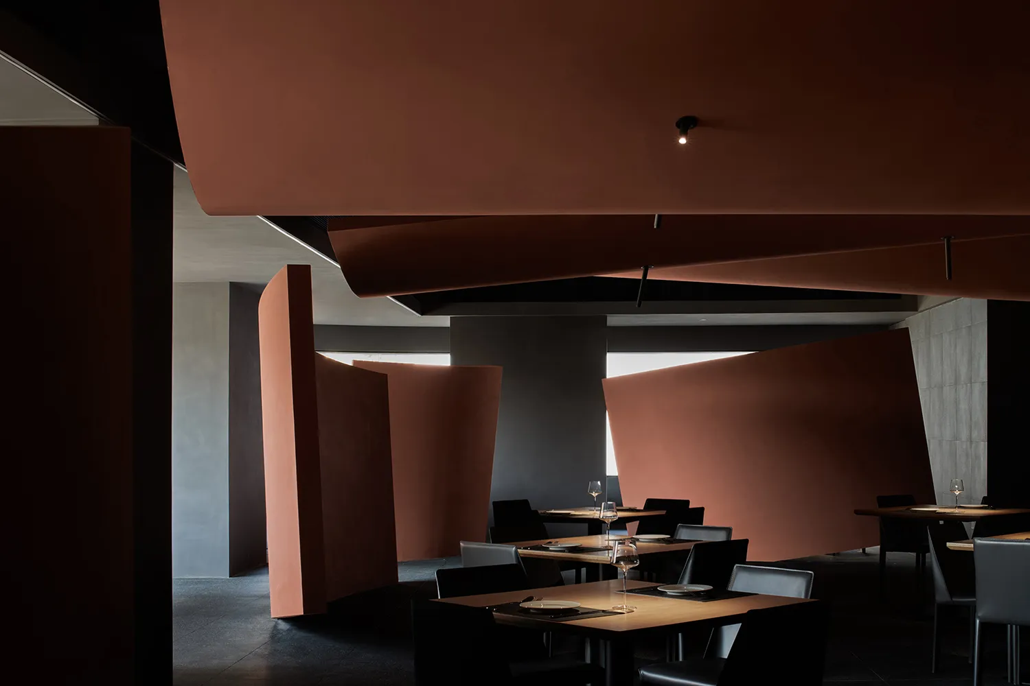 A sleek, modern restaurant interior with metallic elements and contemporary design.