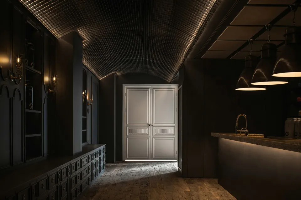 A modern bar with metallic glass bar counter and lighting fixtures.