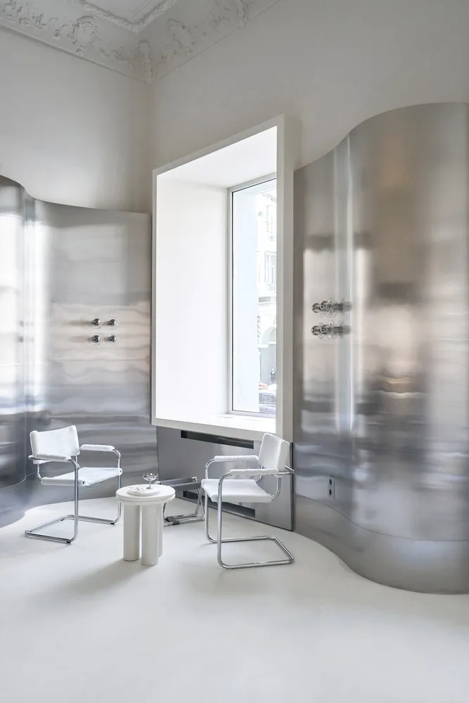 Modern interior featuring metallic walls and minimalist furniture in a sleek, contemporary setting