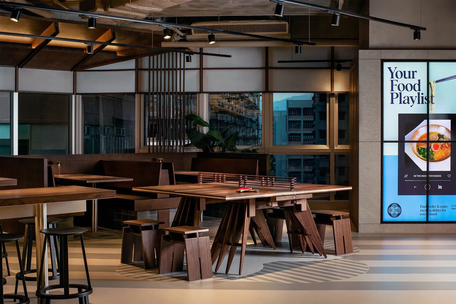 Modern restaurant interior featuring wooden furniture and contemporary design elements.