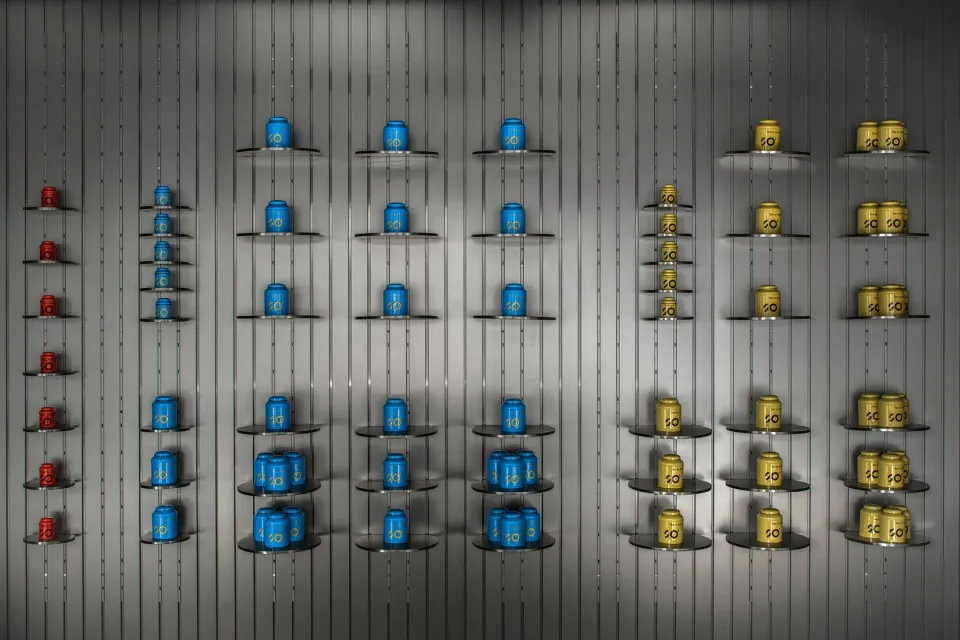 Blue, red, and yellow products displayed on metal shelves in a organized manner.