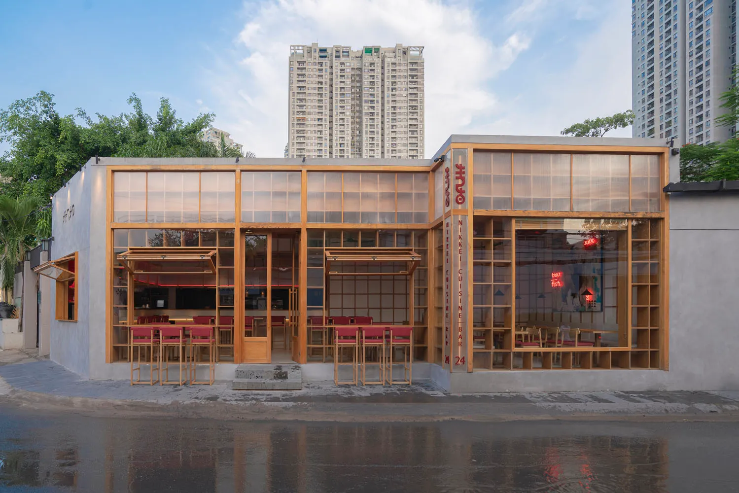 A modern restaurant exterior with glass paneling and wood frame