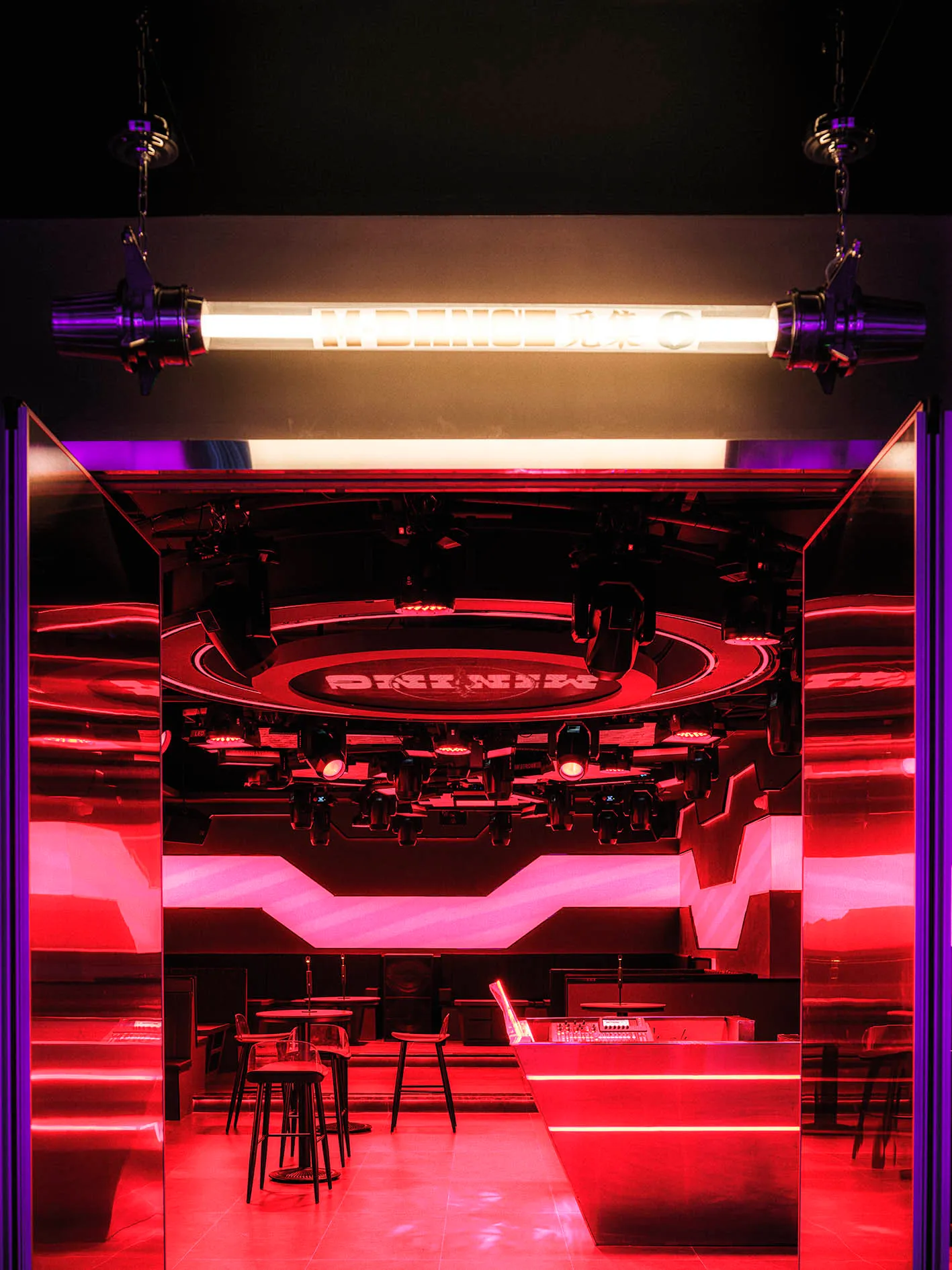 A brightly lit dance floor with metallic elements and red lighting.