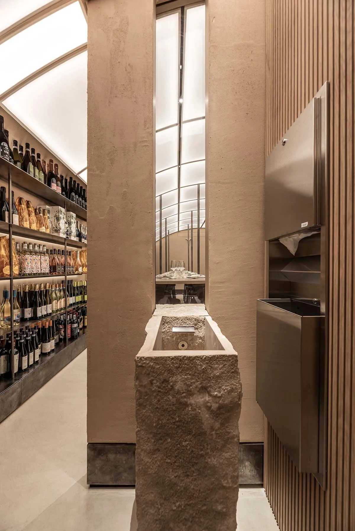 A modern retail store with concrete walls and a glass ceiling.