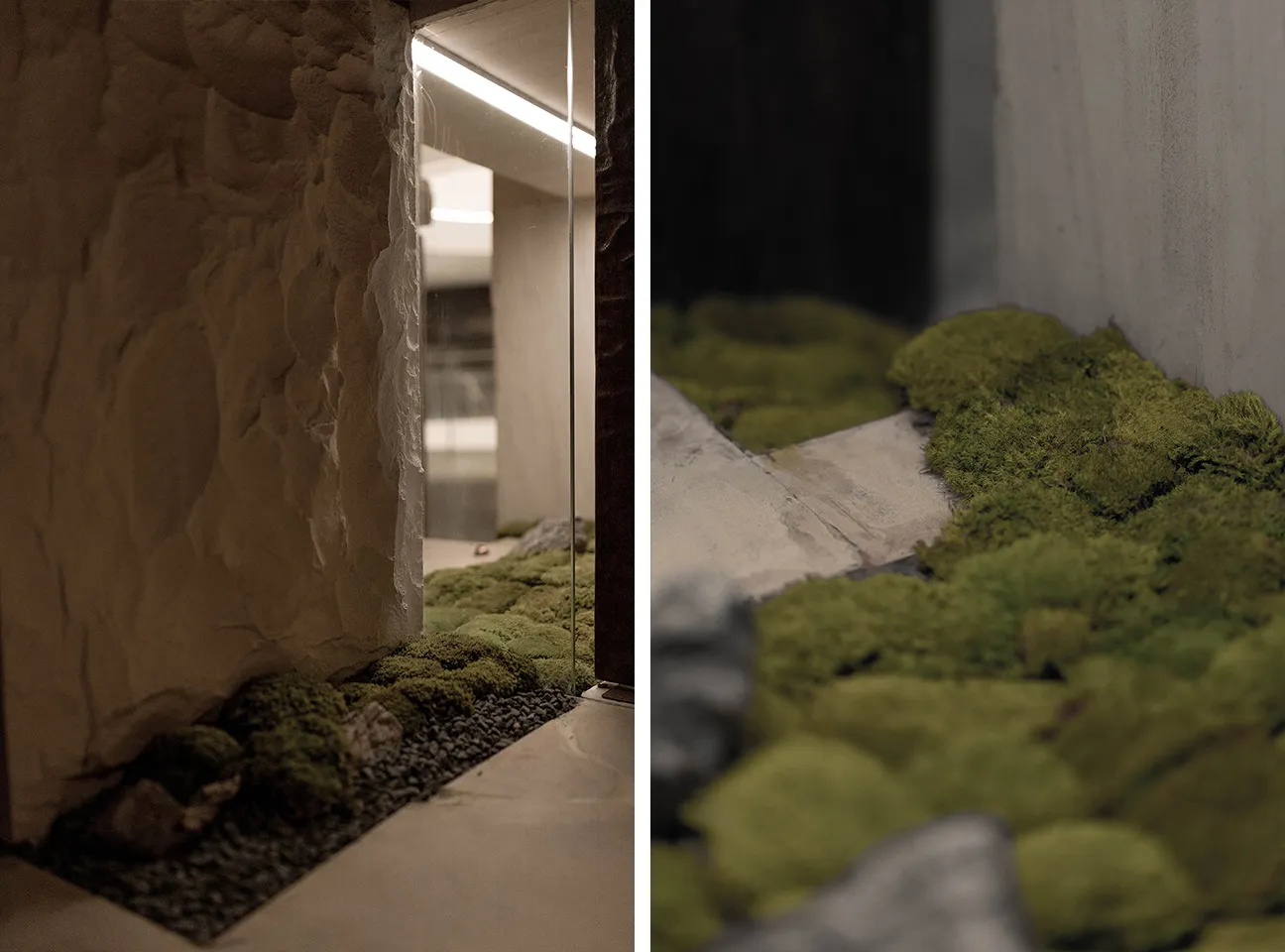 A modern indoor space featuring stone walls and green moss on the floor.