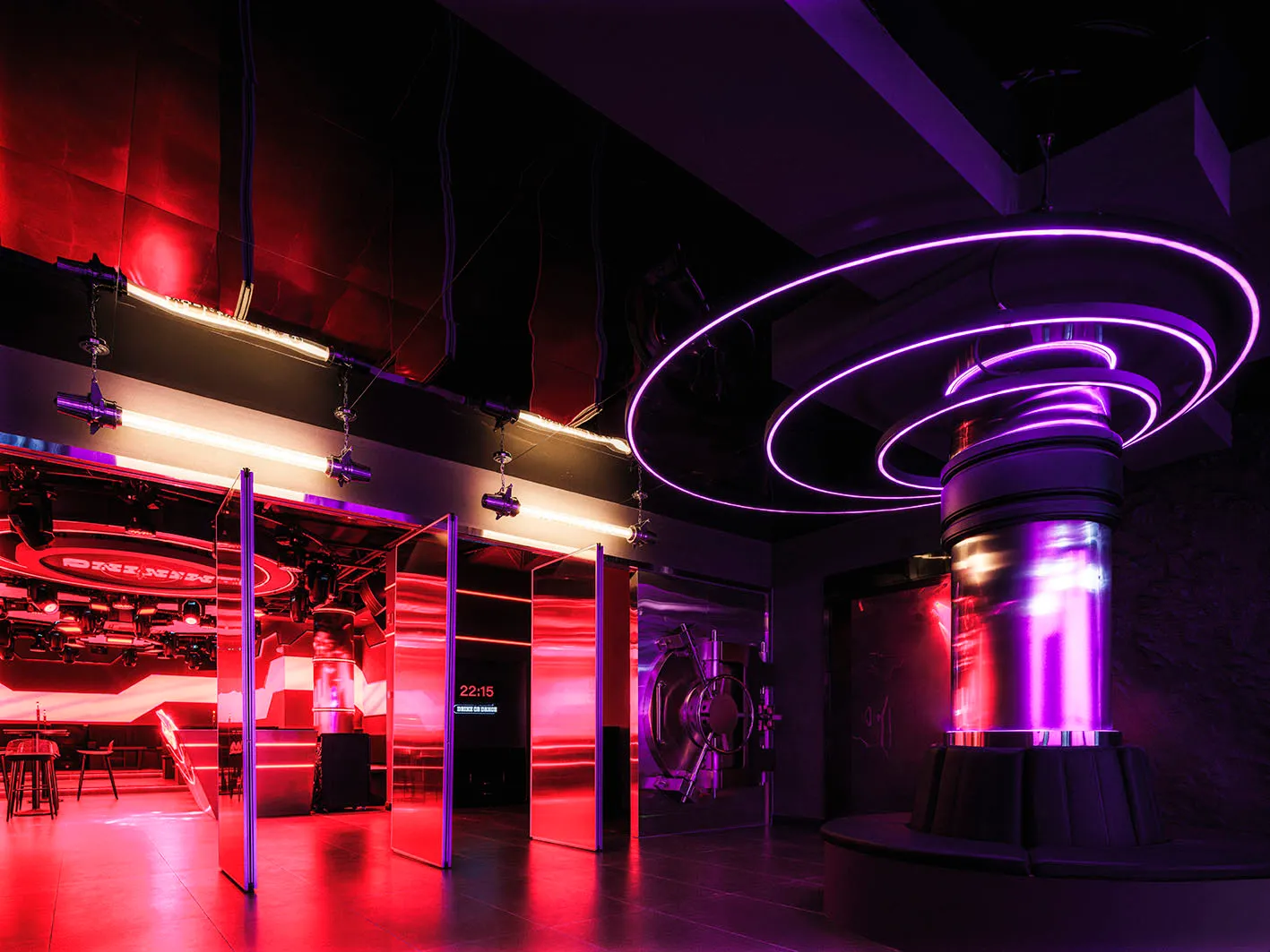 A vibrant nightclub interior with metallic elements and neon lighting.
