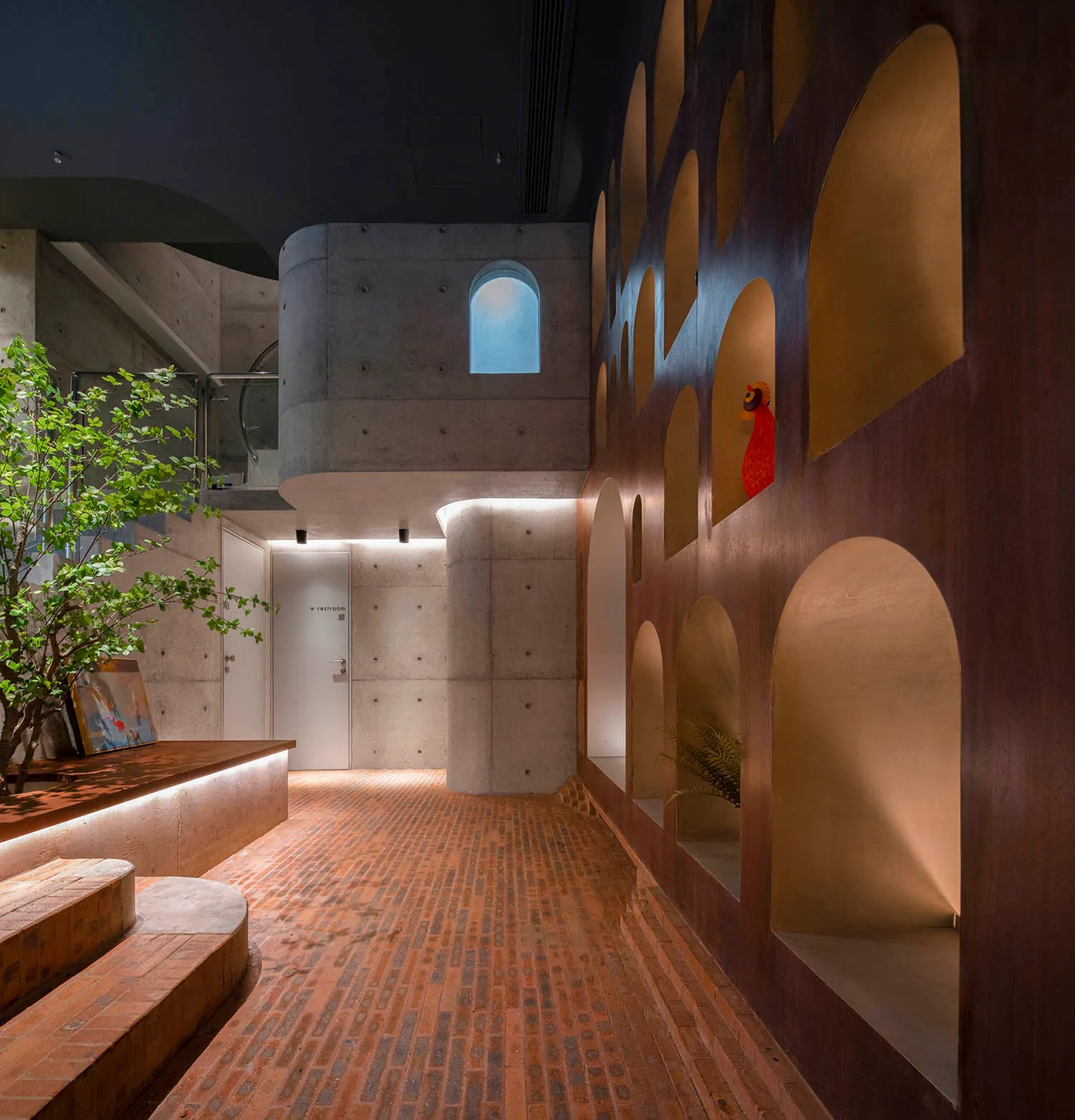 A minimalist interior with a combination of concrete and brick materials.