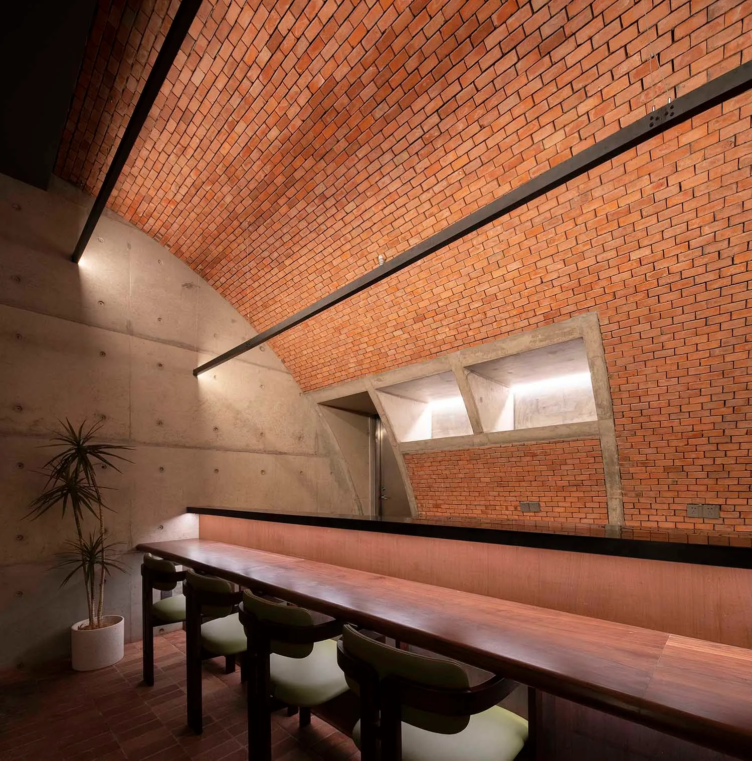 Modern brick bar with concrete interior and seating area.