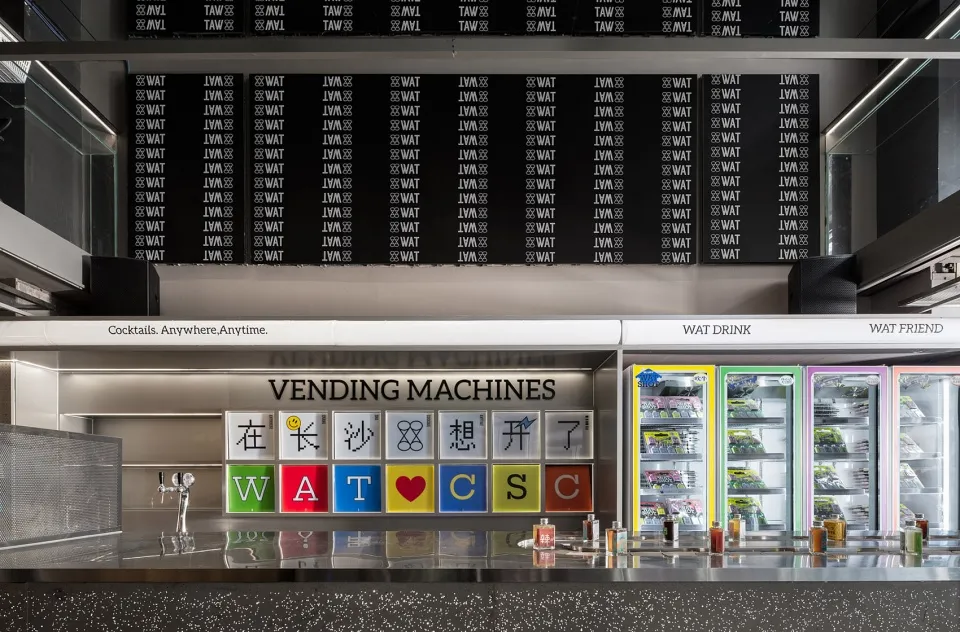 A modern commercial kitchen with colorful vending machines
