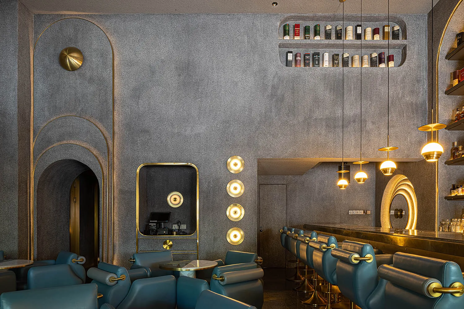 Modern design restaurant bar with concrete walls and hanging lights.