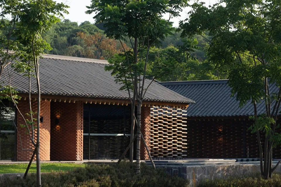 A modern building exterior made of brick, concrete, and wood.
