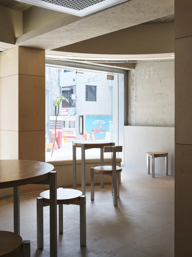 Minimalist design cafe featuring concrete walls and wooden furniture