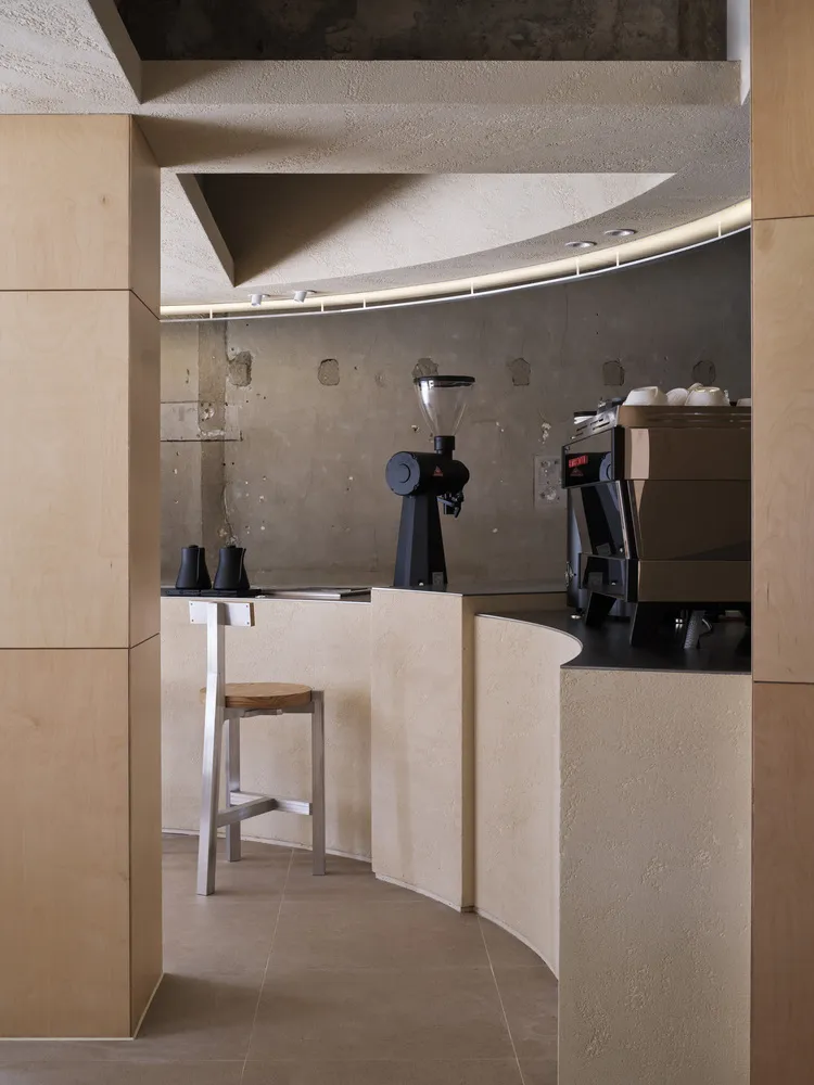 A minimalist coffee bar with a concrete surface.