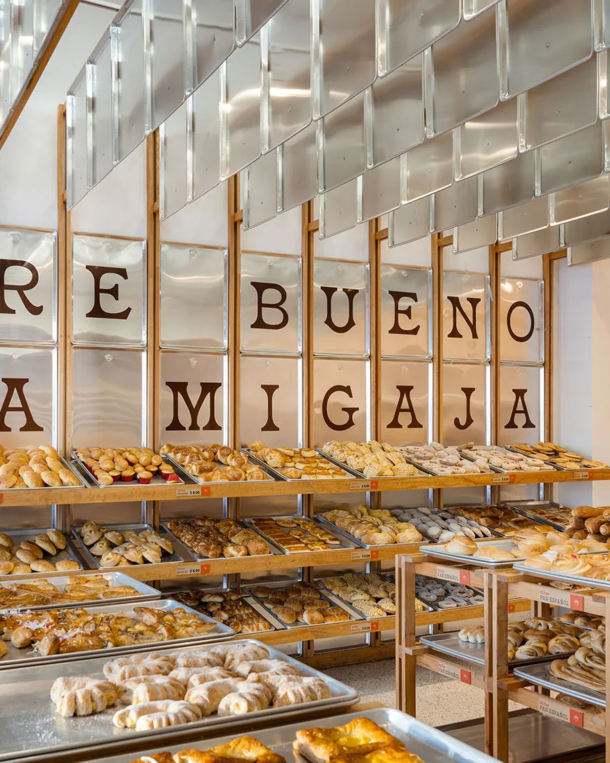 Bakery store interior displaying various baked goods on shelves.