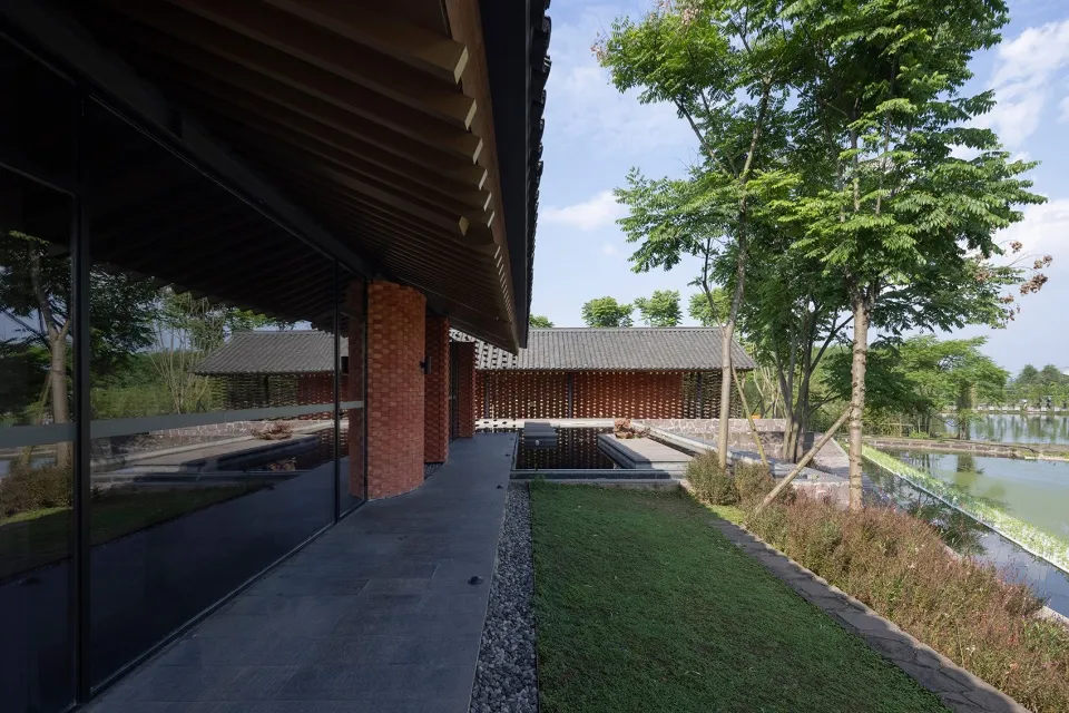 A modern residential building featuring brick and glass materials.