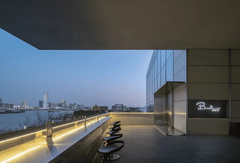 A sleek, modern bar with metallic finishes and a minimalist design.